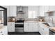 Charming kitchen featuring modern appliances, white cabinets, butcher block counters, and a unique backsplash at 1248 Ursula St, Aurora, CO 80011