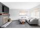 Bright living room with a gray couch, coffee table, and fireplace with a television at 1248 Ursula St, Aurora, CO 80011