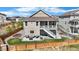 Spacious backyard with patio, seating, lush lawn, and a charming two-story home at 21102 E Stanford Dr, Aurora, CO 80015