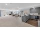 Finished basement with kitchenette, exercise area, and comfortable seating at 21102 E Stanford Dr, Aurora, CO 80015