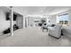 Spacious finished basement with recreational area, white sofas, and a wall-mounted TV at 21102 E Stanford Dr, Aurora, CO 80015