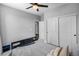 Neutral toned bedroom features sliding closet doors, ceiling fan, and neutral walls at 21102 E Stanford Dr, Aurora, CO 80015