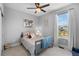 Comfortable bedroom with a large window, neutral carpet, and a playful wall decor at 21102 E Stanford Dr, Aurora, CO 80015