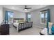This bedroom features natural light, a ceiling fan, and lovely outdoor views at 21102 E Stanford Dr, Aurora, CO 80015