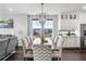 Elegant dining room with large windows and modern light fixtures at 21102 E Stanford Dr, Aurora, CO 80015