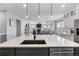 Open-concept design with a kitchen island, stainless steel appliances, and seamless flow into the dining and living areas at 21102 E Stanford Dr, Aurora, CO 80015