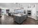 Open-concept kitchen flowing into the dining and living areas, showcasing modern appliances and a spacious island at 21102 E Stanford Dr, Aurora, CO 80015