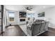 Inviting living room featuring a stone fireplace, hardwood floors, and large windows providing ample natural light at 21102 E Stanford Dr, Aurora, CO 80015