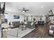 Spacious living area with hardwood floors, a ceiling fan, and an open layout, seamlessly connecting to the kitchen at 21102 E Stanford Dr, Aurora, CO 80015