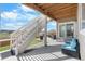Relaxing covered patio with outdoor seating, open stairs, and access to the yard and grassy open space at 21102 E Stanford Dr, Aurora, CO 80015