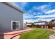 View of the backyard featuring a cement patio, lawn, and sliding glass door into the home at 4184 Netherland St, Denver, CO 80249