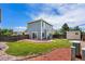 A spacious backyard featuring a lawn, storage shed and a concrete patio area off of the back of the home at 4184 Netherland St, Denver, CO 80249