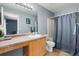 A full bathroom includes a vanity with a sink, a large mirror, and a shower-tub combination at 4184 Netherland St, Denver, CO 80249