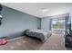 Carpeted bedroom offers a neutral color palette and a window with exterior views at 4184 Netherland St, Denver, CO 80249