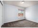Bedroom features a window with neighborhood views and a large closet for ample storage at 4184 Netherland St, Denver, CO 80249
