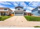 Exterior view of home with an expansive concrete driveway and well-manicured lawn at 4184 Netherland St, Denver, CO 80249
