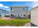 Back exterior view of the home with large windows, patio, shed, and grassy backyard at 4184 Netherland St, Denver, CO 80249