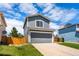 Charming two-story home features a gray exterior, red tile roof, and attached garage at 4184 Netherland St, Denver, CO 80249