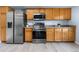 Kitchen featuring stainless steel appliances, light wood cabinets, and hardwood floors at 4184 Netherland St, Denver, CO 80249