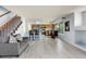 Open-concept living area leads into kitchen and dining area with hardwood floors at 4184 Netherland St, Denver, CO 80249
