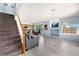 Open-concept living area with hardwood floors and stairs leading to the upper level at 4184 Netherland St, Denver, CO 80249