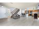 View of open-concept living area with hardwood floors, dining area, and a staircase at 4184 Netherland St, Denver, CO 80249