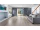 Bright living room features sleek floors, sliding glass doors to the backyard, and an adjacent staircase at 4184 Netherland St, Denver, CO 80249