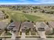 Aerial view showcasing multiple homes in a friendly neighborhood with lush green lawns and well-maintained landscaping at 21780 E Heritage Pkwy, Aurora, CO 80016