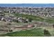 An aerial view showcasing a golf course community with beautiful homes and stunning views of green space at 21780 E Heritage Pkwy, Aurora, CO 80016
