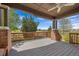 Covered back deck with brick columns and wood railings, perfect for outdoor entertaining at 21780 E Heritage Pkwy, Aurora, CO 80016