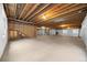 Unfinished basement area with exposed ceiling beams, concrete floor, and potential for customization at 21780 E Heritage Pkwy, Aurora, CO 80016