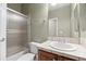Bathroom featuring a single sink vanity, a shower and tiled walls at 21780 E Heritage Pkwy, Aurora, CO 80016
