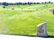 Scenic view of a golf driving range on a sunny day, complete with manicured lawns and clear signage at 21780 E Heritage Pkwy, Aurora, CO 80016