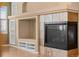 Living room fireplace with hearth, cabinets and shelving located on hardwood flooring at 21780 E Heritage Pkwy, Aurora, CO 80016