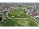 Stunning aerial shot of a lush golf course, featuring manicured greens, sand traps, and well-defined fairways at 21780 E Heritage Pkwy, Aurora, CO 80016