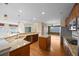 Open-concept kitchen with stainless steel appliances, island and hardwood floors with natural lighting at 21780 E Heritage Pkwy, Aurora, CO 80016