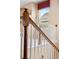 Staircase with wooden banister and white spindles, bathed in natural light at 21780 E Heritage Pkwy, Aurora, CO 80016