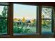 Bright picture windows showcase an outdoor view of green trees and snow-capped mountains at 21780 E Heritage Pkwy, Aurora, CO 80016