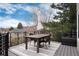 Relaxing outdoor deck features a dining table with chairs, plus scenic views of the natural landscape at 49 Dawn Heath Cir, Littleton, CO 80127