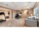 Finished basement features neutral carpet, a home gym, and an office area with a comfortable sofa at 49 Dawn Heath Cir, Littleton, CO 80127