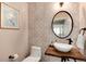 Elegant powder room with decorative tile wall, an oval mirror, and a stylish live-edge wood sink at 49 Dawn Heath Cir, Littleton, CO 80127