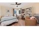 Bedroom with warm color scheme, complemented by large windows and an inviting chair at 49 Dawn Heath Cir, Littleton, CO 80127