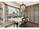 Dining area with a large window, decorative chandelier, and built-in storage cabinets at 49 Dawn Heath Cir, Littleton, CO 80127