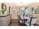 Lovely dining room with contemporary decor, hardwood floors, and ample natural light for Gathering meals at 49 Dawn Heath Cir, Littleton, CO 80127