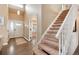 Bright entryway featuring a staircase and wood floors, leading to the rest of the home at 49 Dawn Heath Cir, Littleton, CO 80127