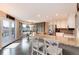 Bright kitchen featuring granite countertops, a breakfast bar, stainless steel appliances and dark hardwood floors at 49 Dawn Heath Cir, Littleton, CO 80127