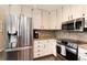 Kitchen area with stainless appliances, granite counters, modern backsplash and white cabinets at 49 Dawn Heath Cir, Littleton, CO 80127