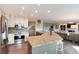 Open kitchen with granite counters, stainless appliances and adjacent staircase and living area at 49 Dawn Heath Cir, Littleton, CO 80127