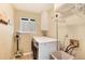 Bright laundry room featuring modern washer and dryer, storage cabinets and a window for natural light at 49 Dawn Heath Cir, Littleton, CO 80127