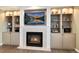 Inviting living room with fireplace, built-in shelving, and a large television at 49 Dawn Heath Cir, Littleton, CO 80127